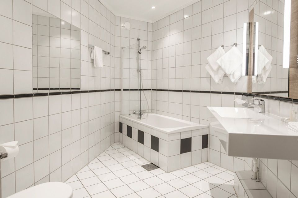Bathroom, interior with white tiles. Hotell Bondeheimen, Oslo. Photo