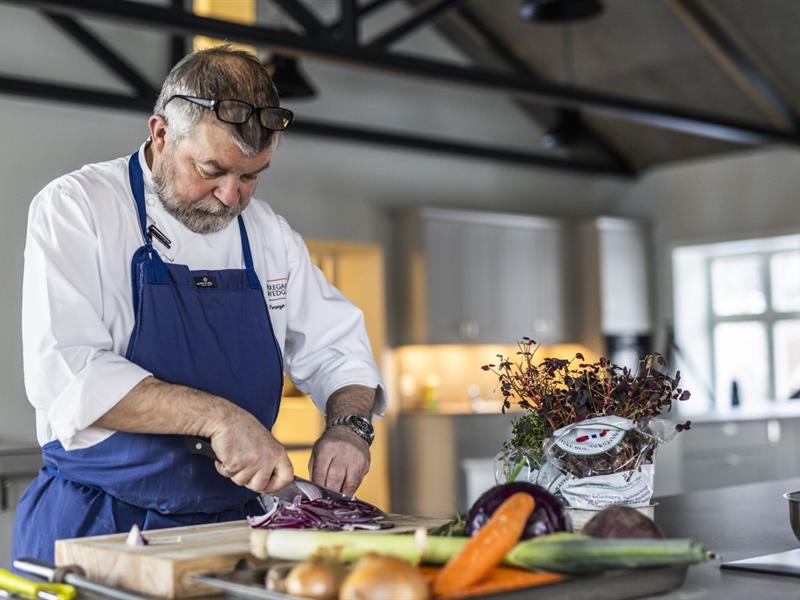 Chef cooking, cutting vegetables