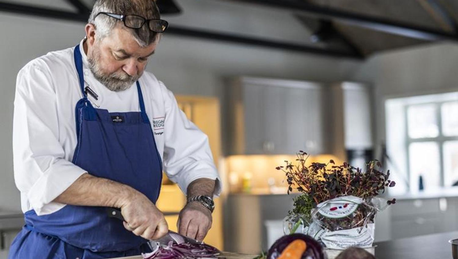 Chef cooking, cutting vegetables