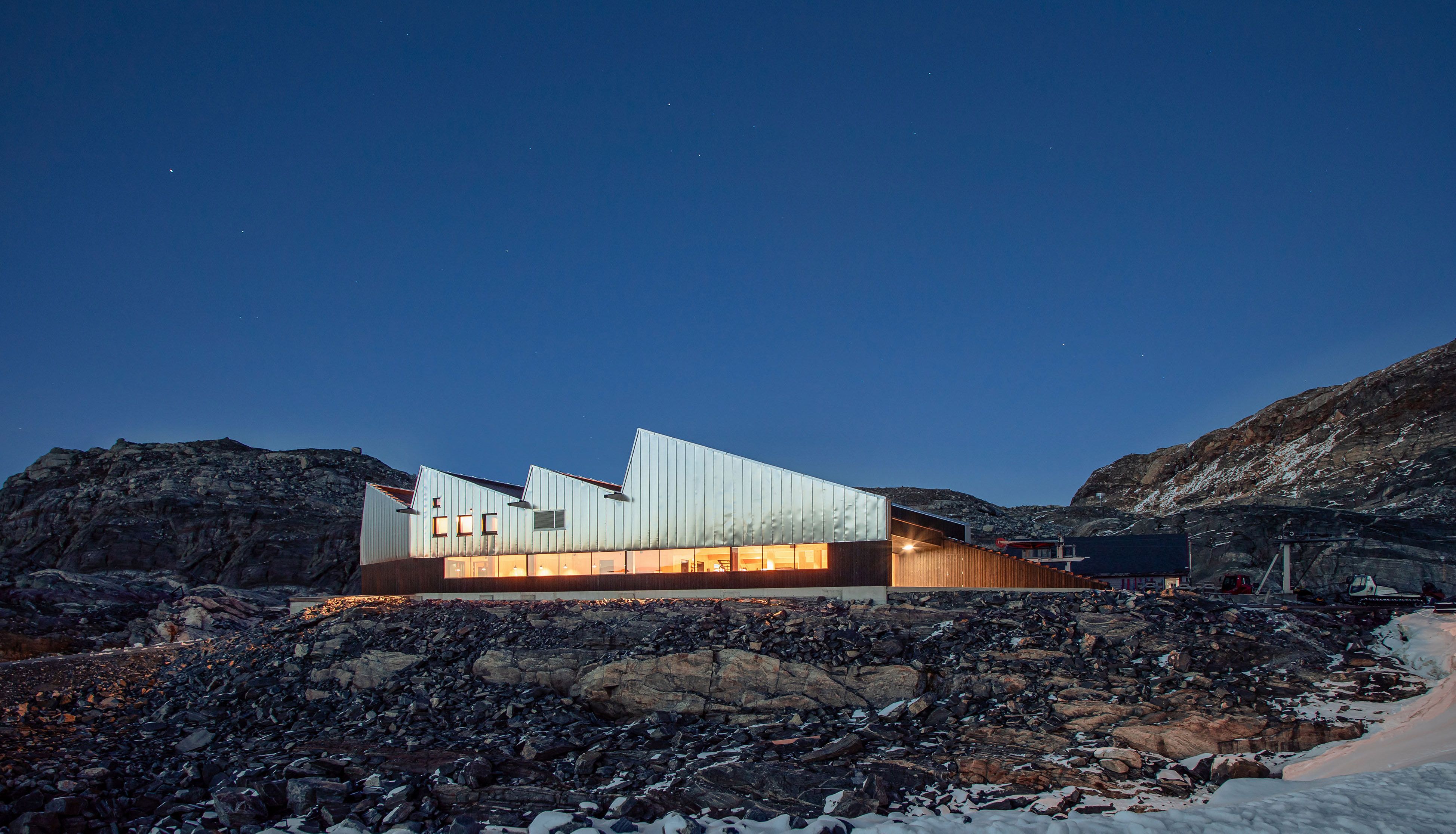 Fonna1199's welcome center and restaurant sit in the rugged mountain landscape, with modern design blending harmoniously with the surrounding nature