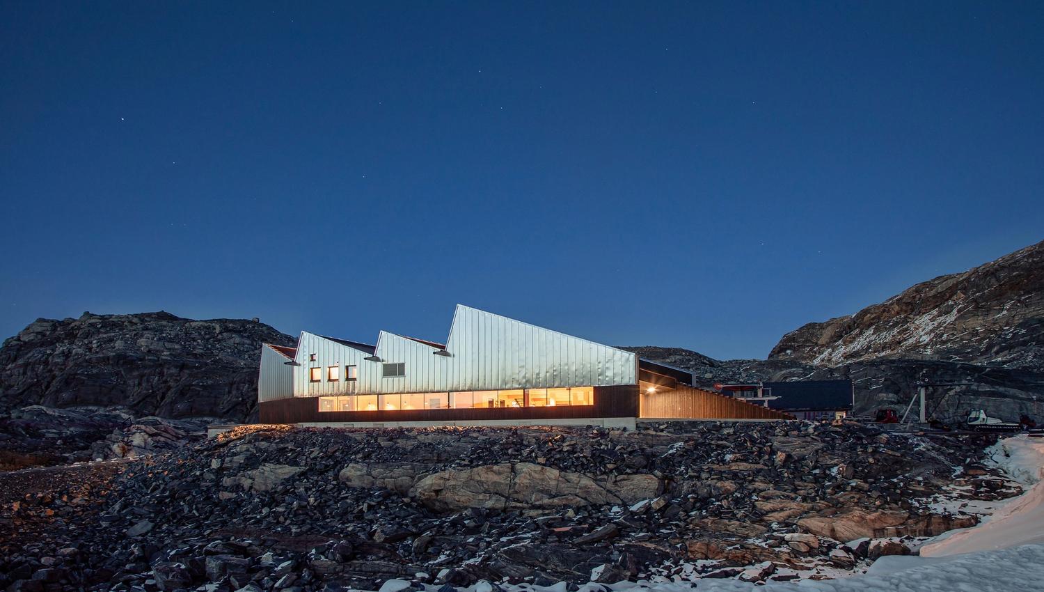 Fonna1199's welcome center and restaurant sit in the rugged mountain landscape, with modern design blending harmoniously with the surrounding nature