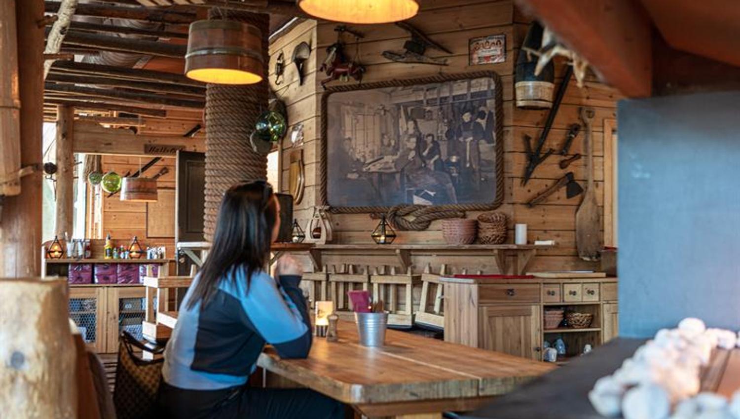 Girl stting at a table.