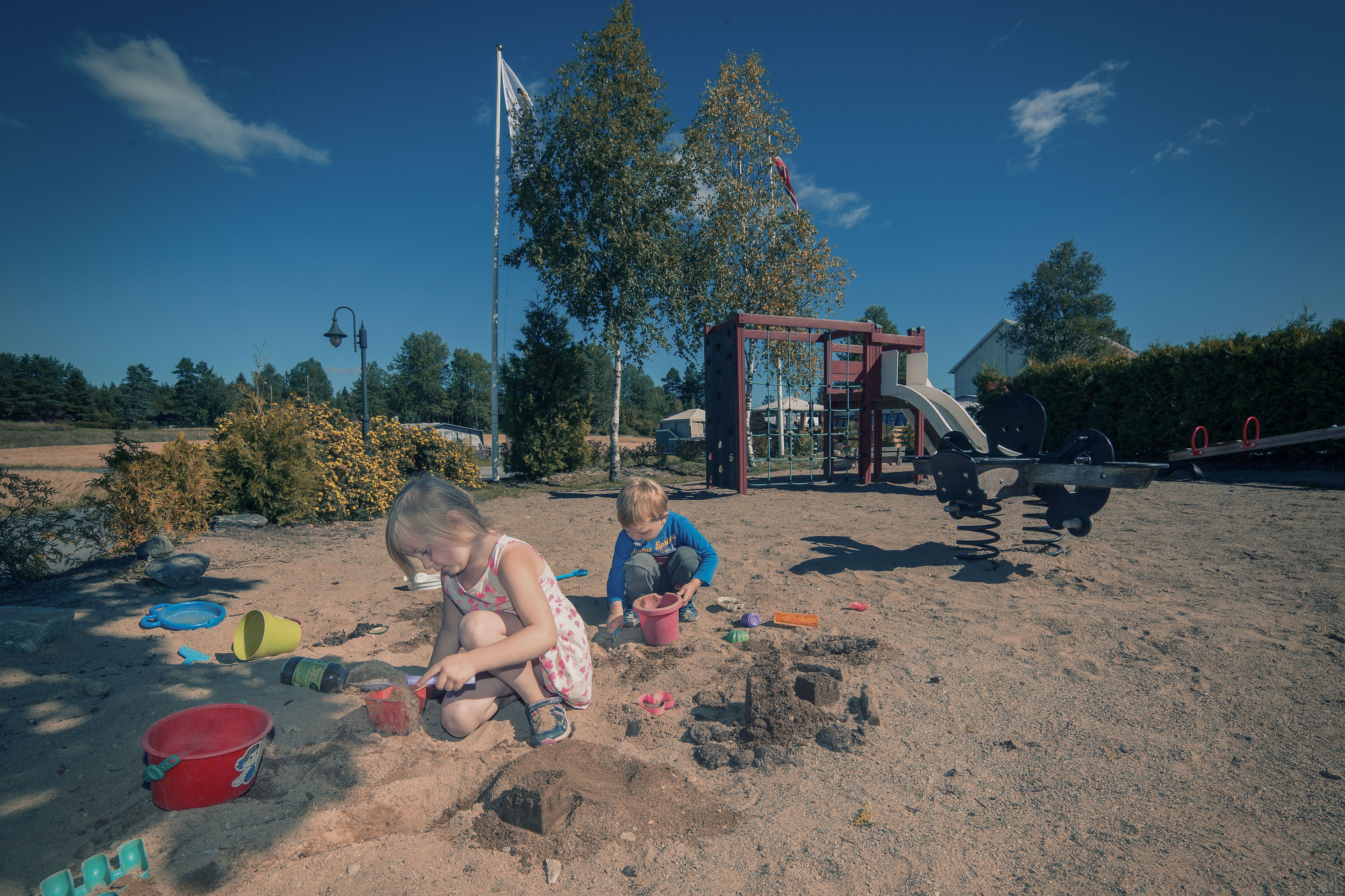 Two children are playing on the playground