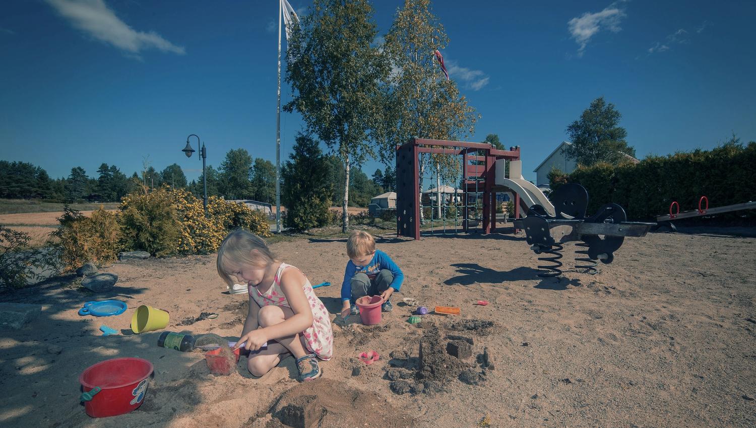 Two children are playing on the playground