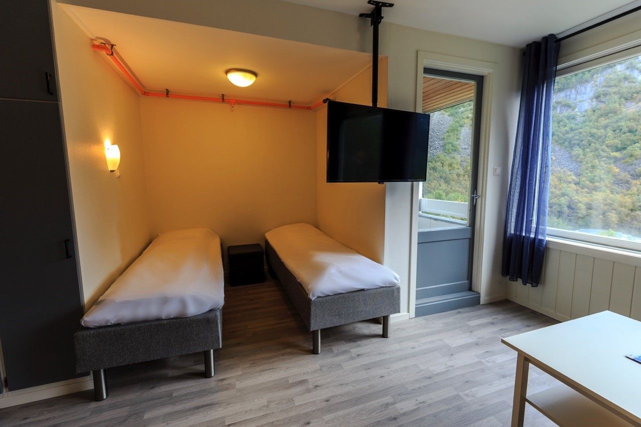 Comfortable twin bedroom with fjord views at Trolltunga Guesthouse.