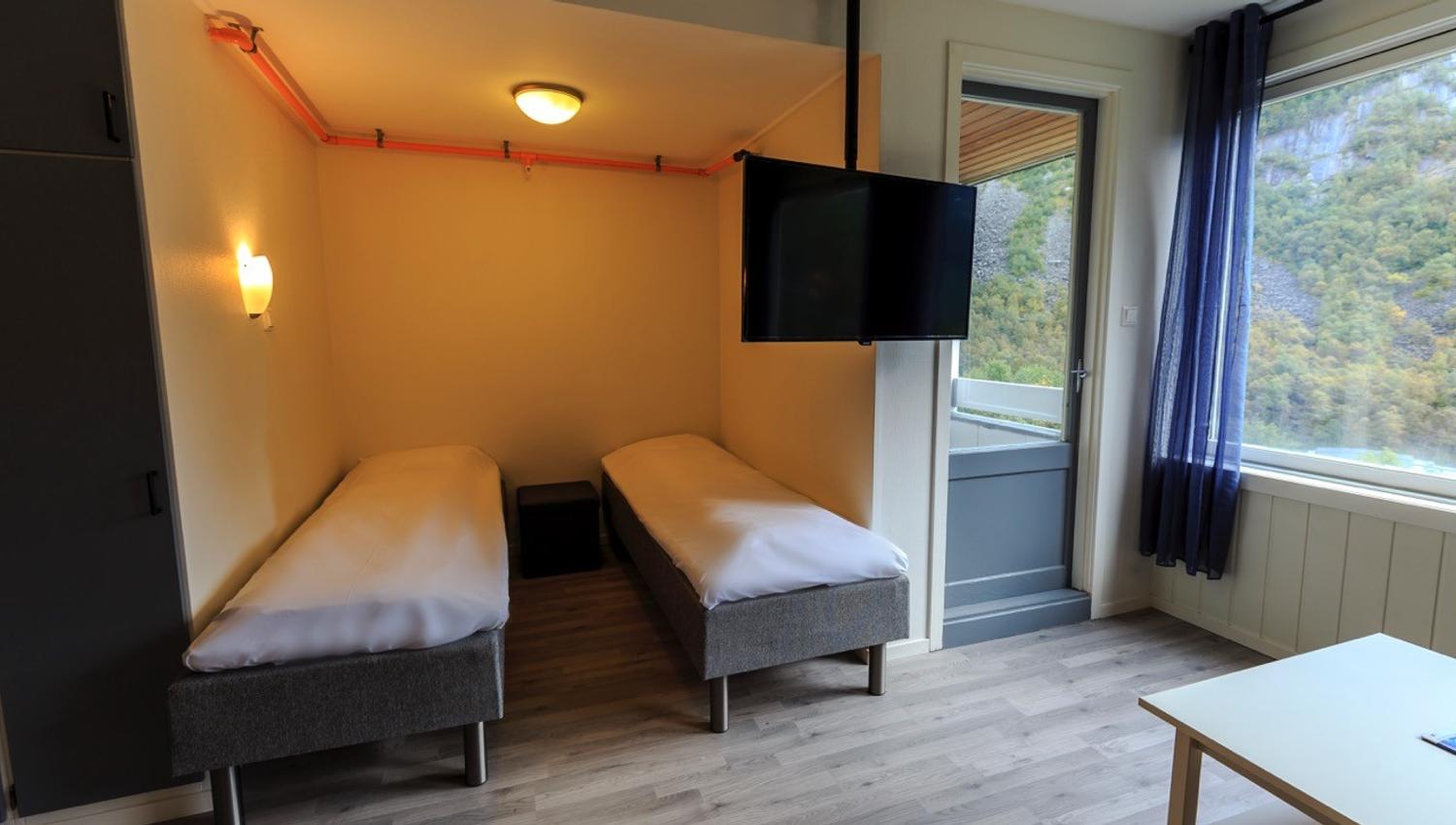 Comfortable twin bedroom with fjord views at Trolltunga Guesthouse.
