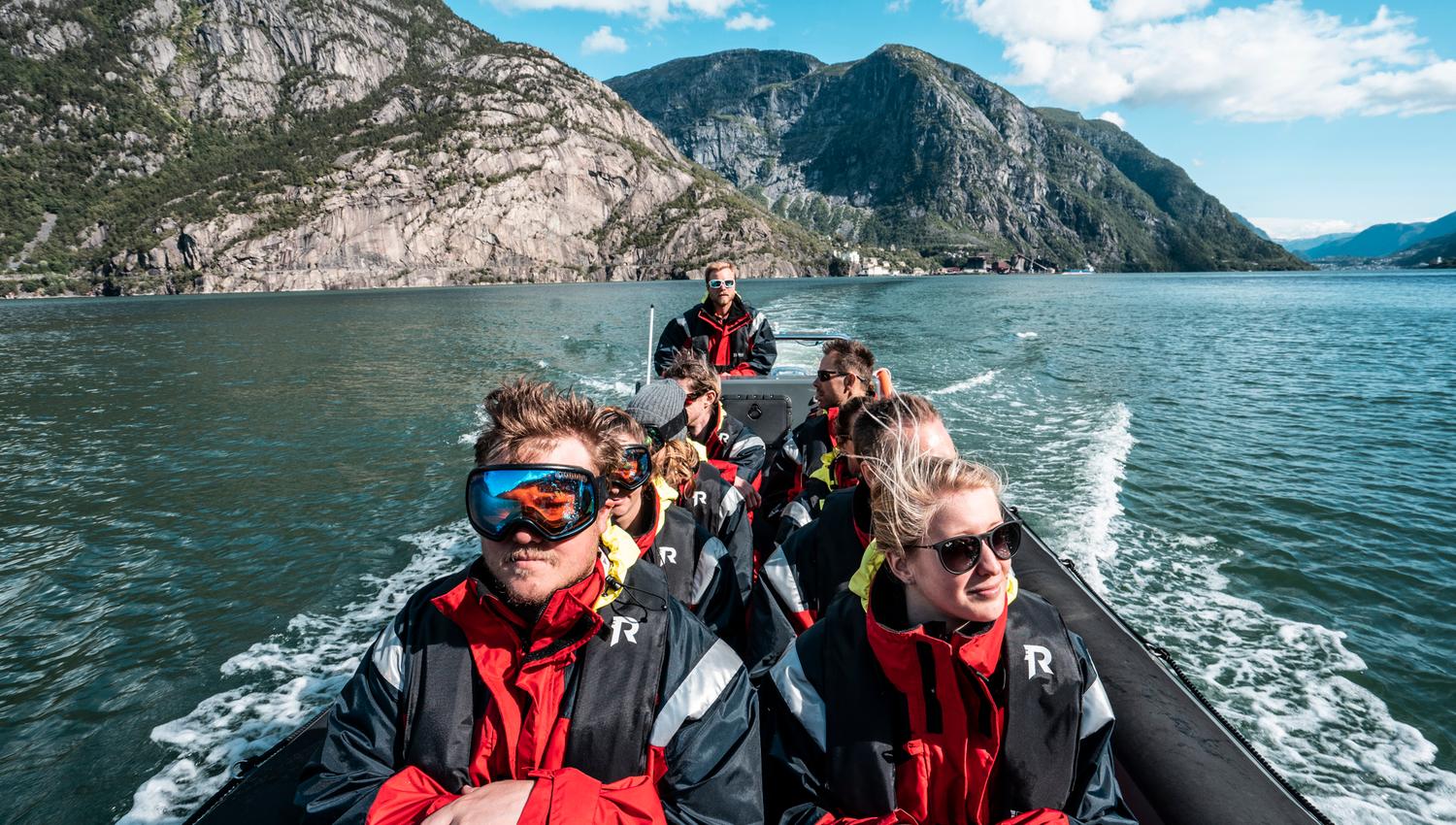Adventurous tourists on a RIB safari surrounded by Norway’s raw nature.