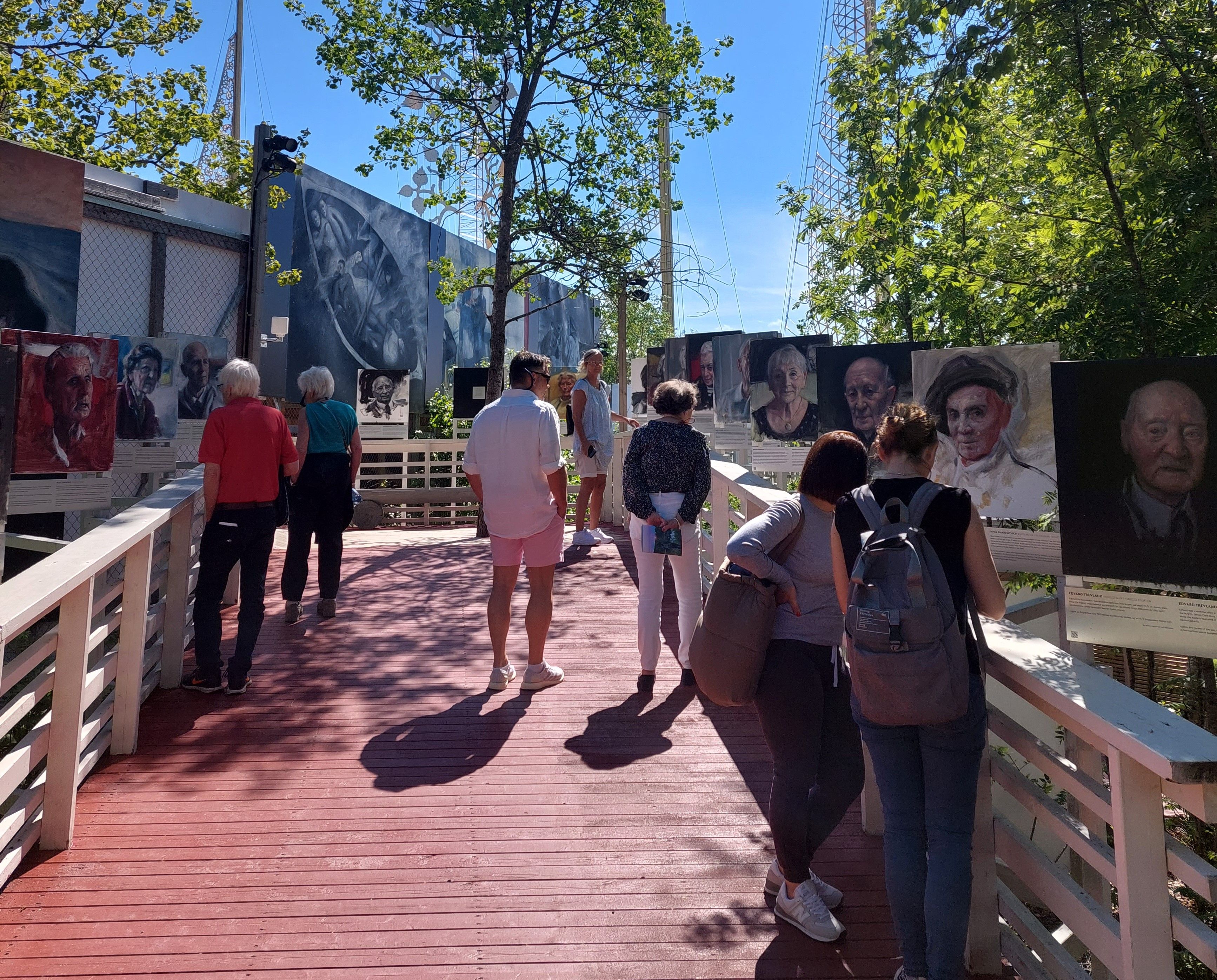 People looking at outdoor exhibition in summer