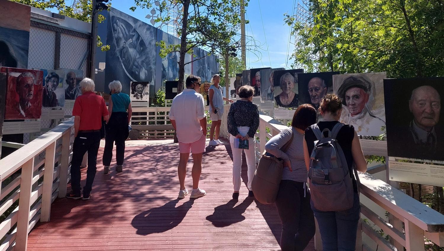 People looking at outdoor exhibition in summer