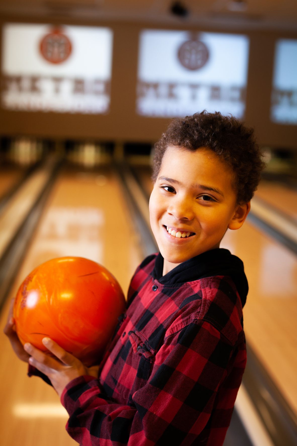 Boy with bowling ball in hand