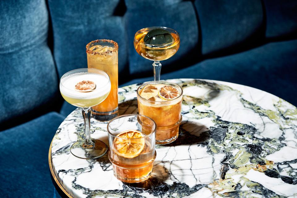 Five different drinks on a marble table