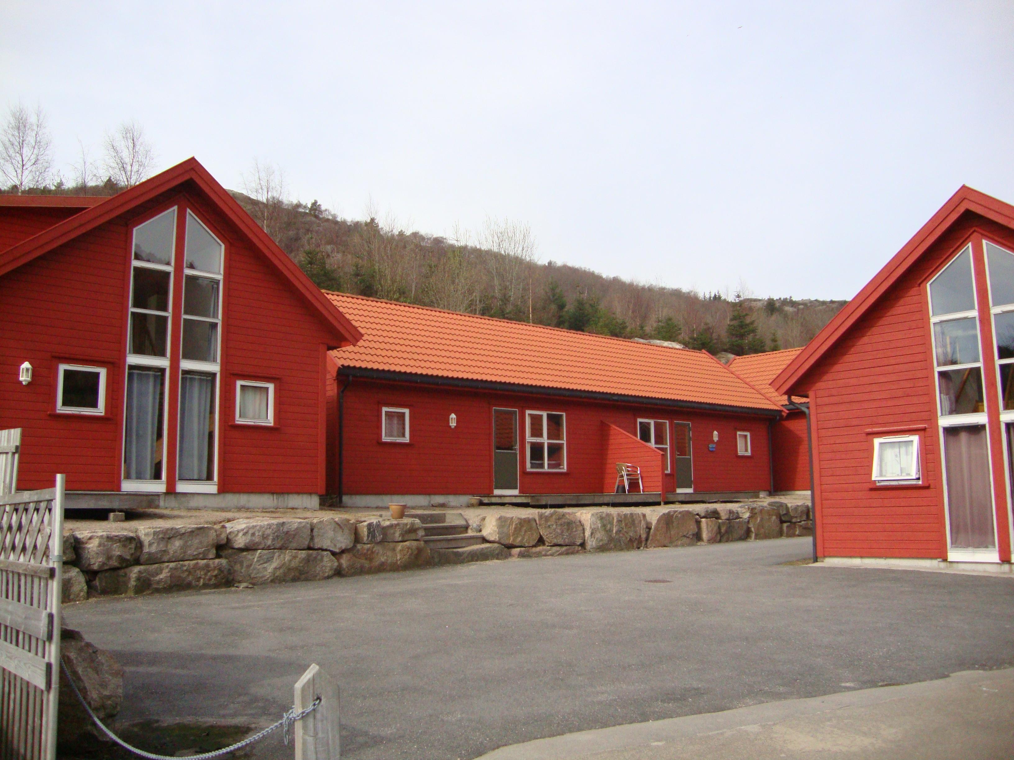 Red cabins with tall windows.