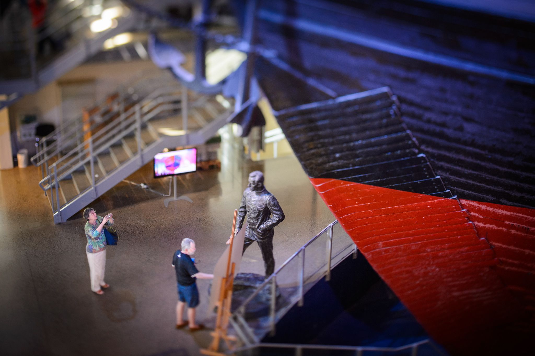 Two tourists standing in front of the ship.