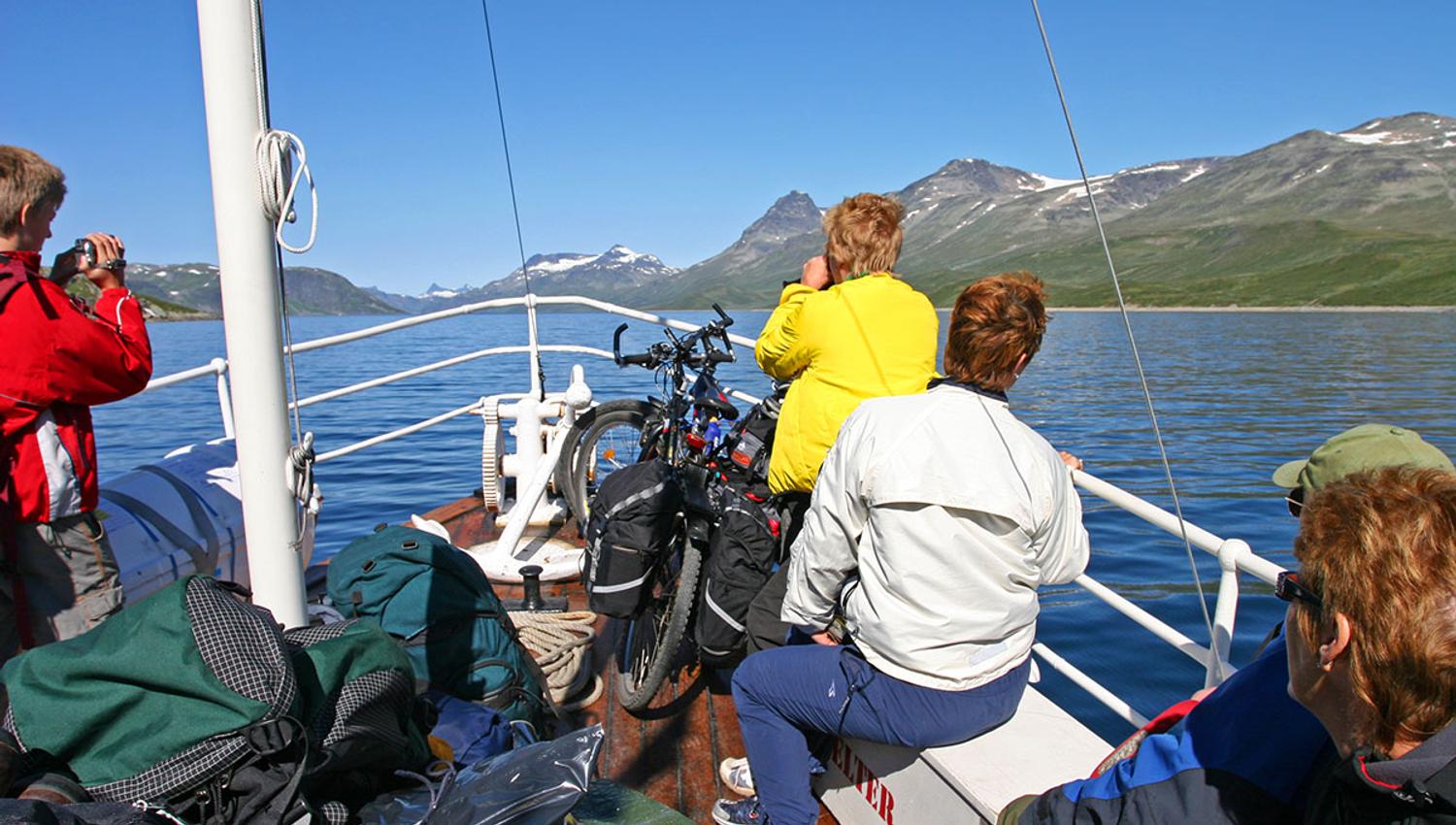 Sailing on M/B Bitihorn across Lake Bygdin, blue skies and 2000m-summits in the background