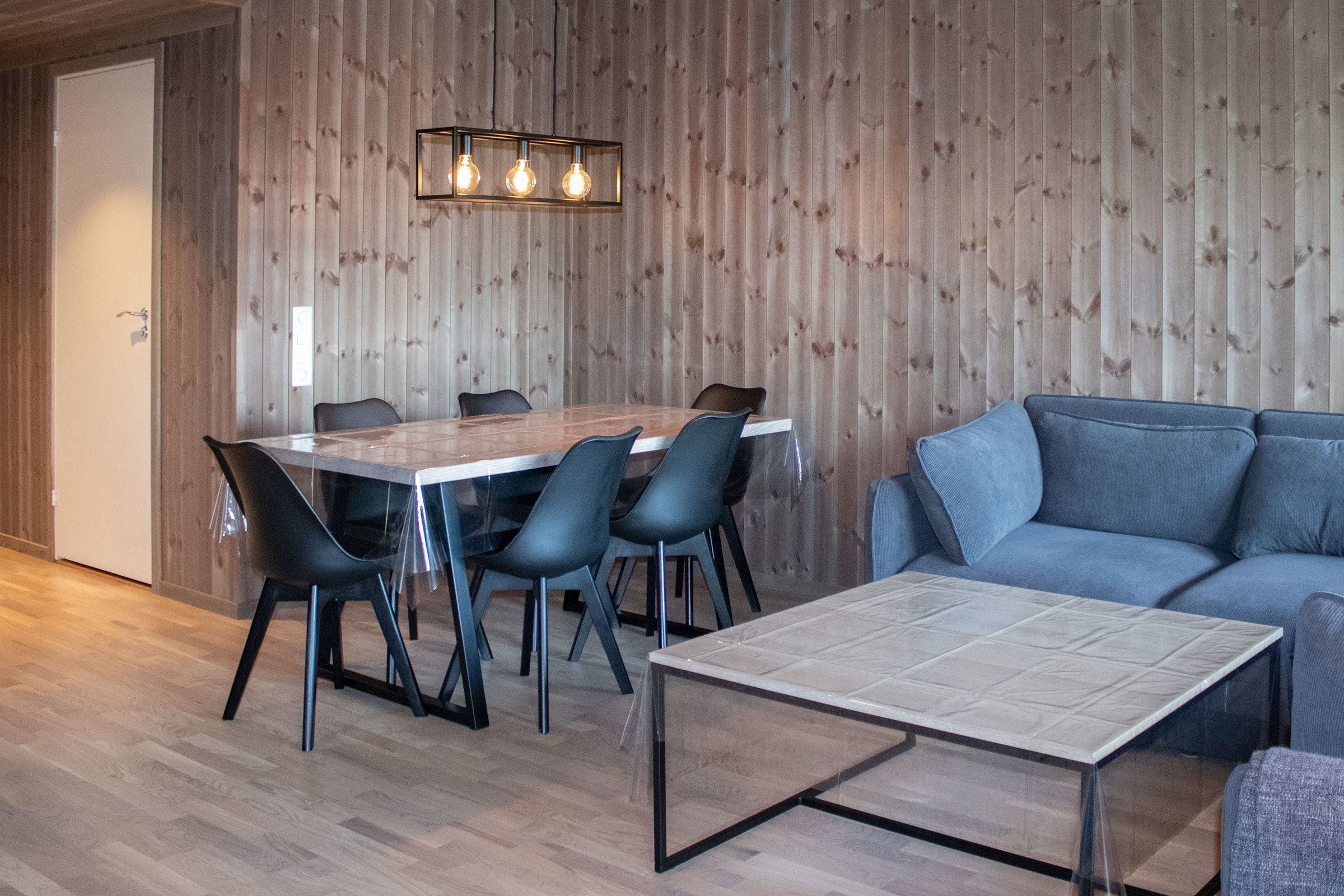 A room with a table and chairs.