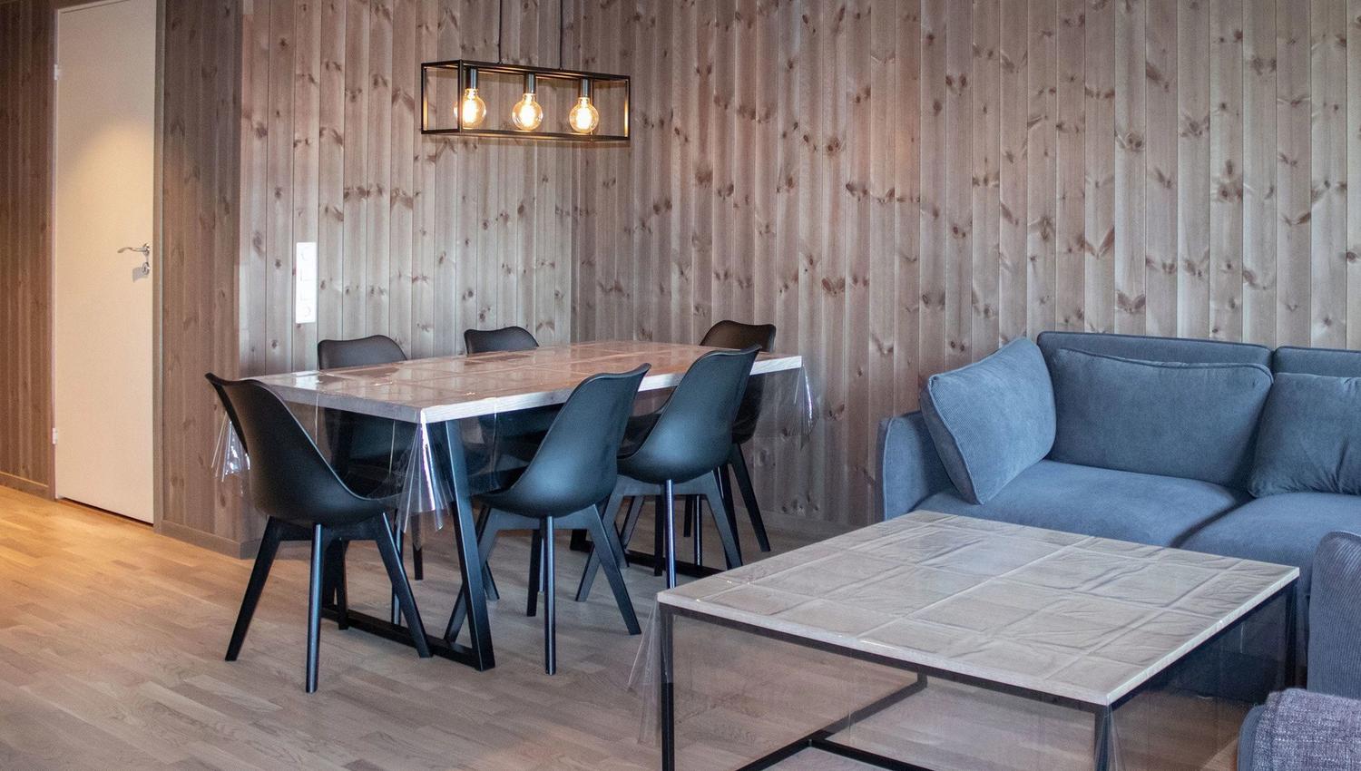 A room with a table and chairs.