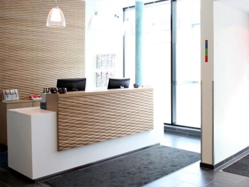 Modern reception area with a wooden front, large windows, and pendant lights.