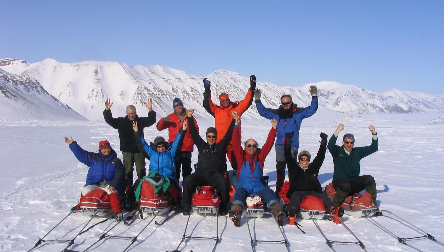 A tour group posing for the camera on their sleds