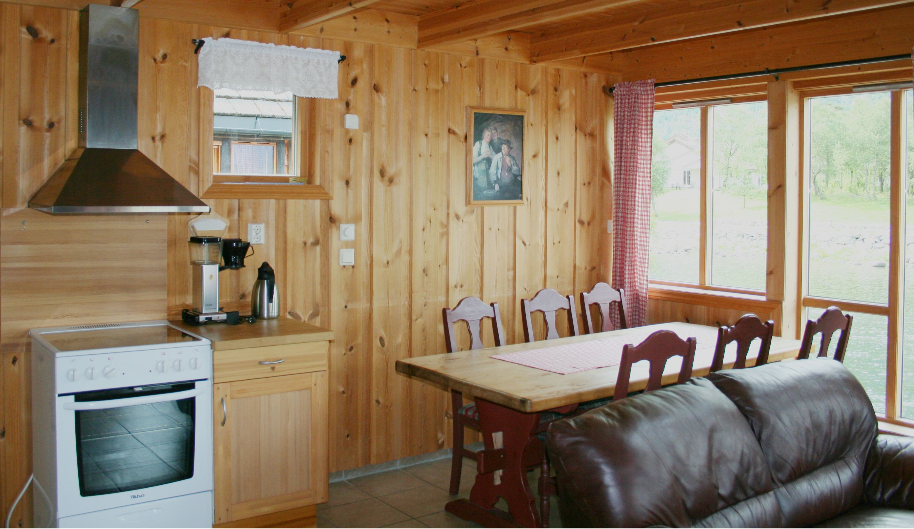 The kitchen and sitting area inside one of the cabins. Wooden walls and red interior.