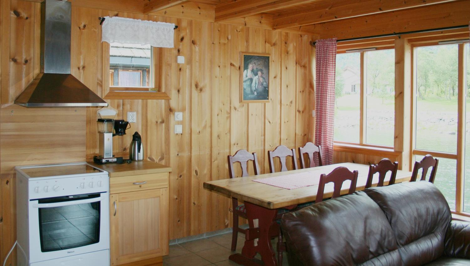 The kitchen and sitting area inside one of the cabins. Wooden walls and red interior.