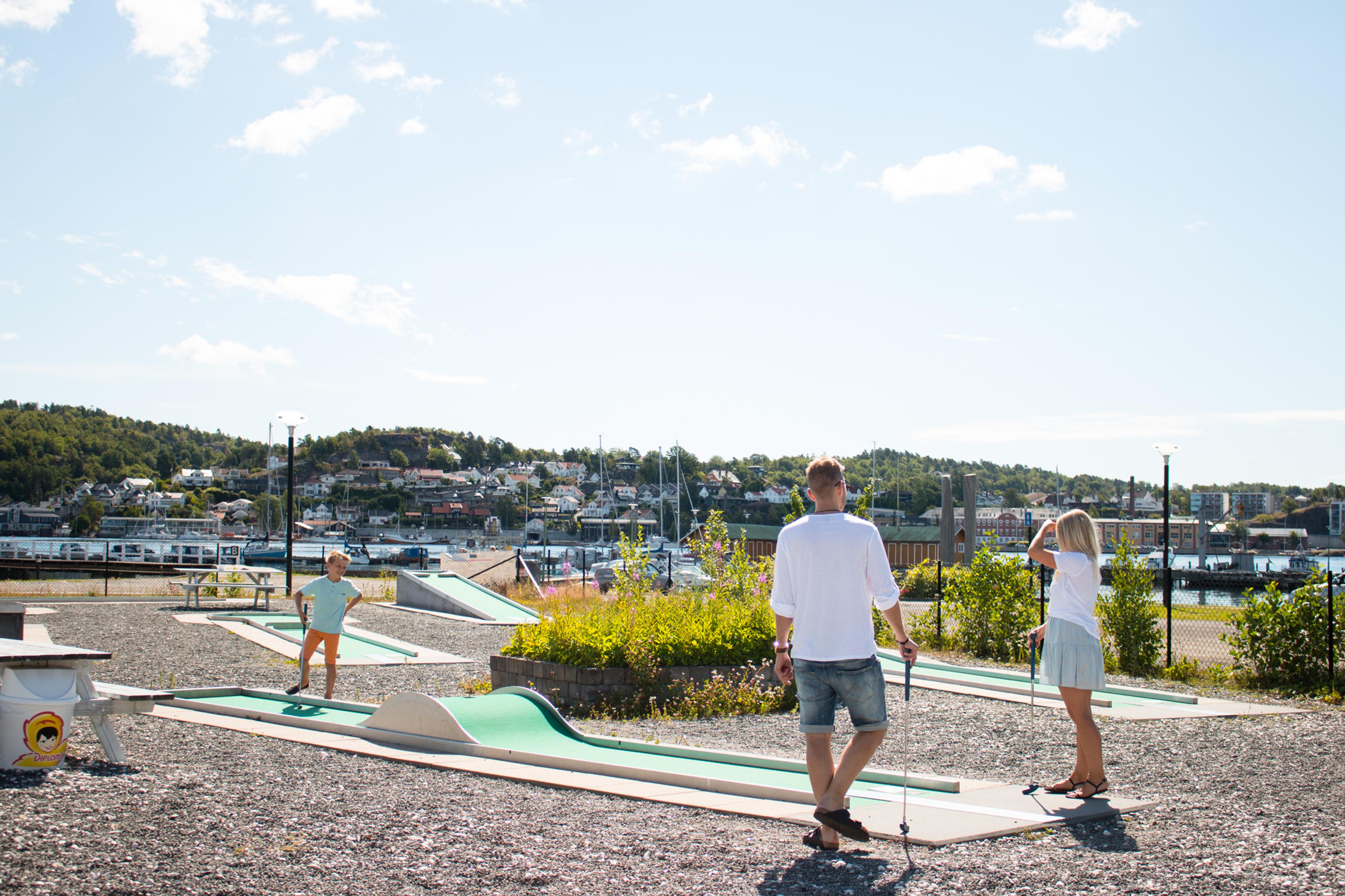 Family playing mini golf
