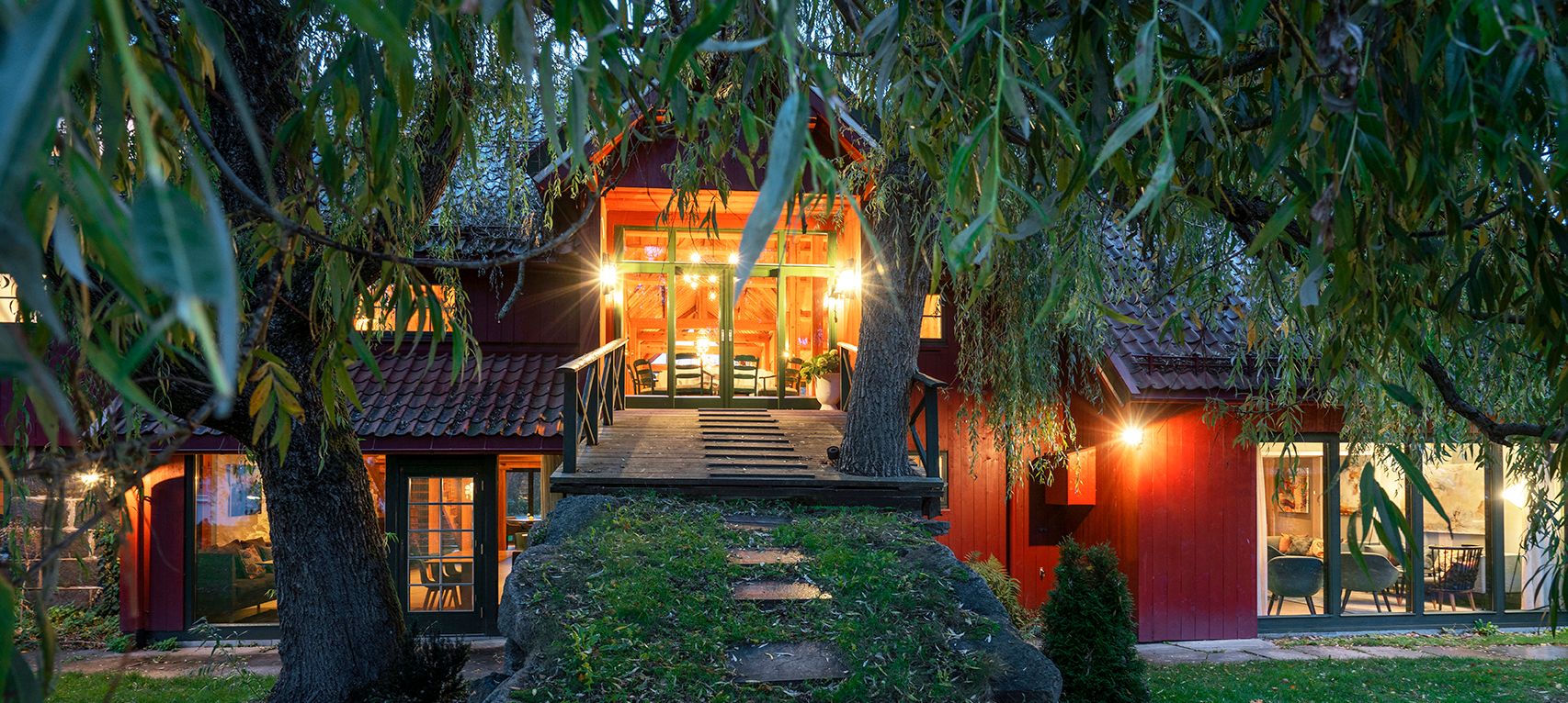 Bridge up to the barn, in the evening, the barn lights up in the dark.