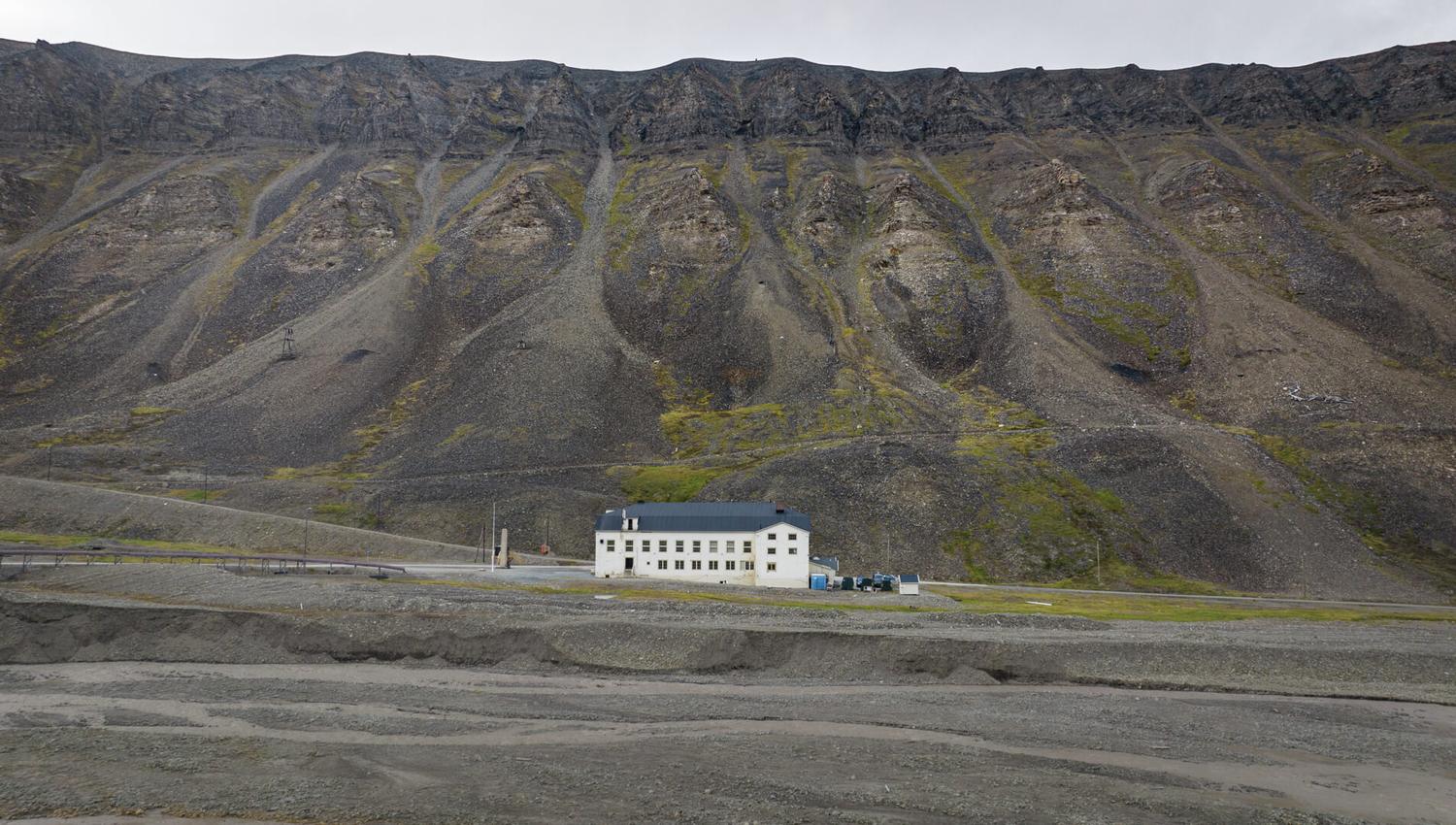 The building "Huset" with seen from outside with mountains in the background