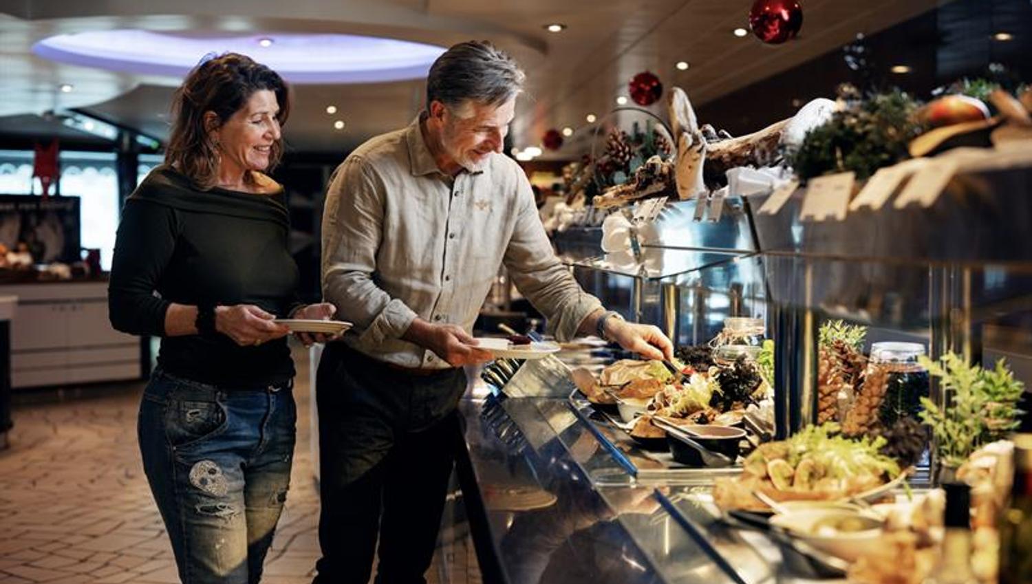 People serving food at buffet,