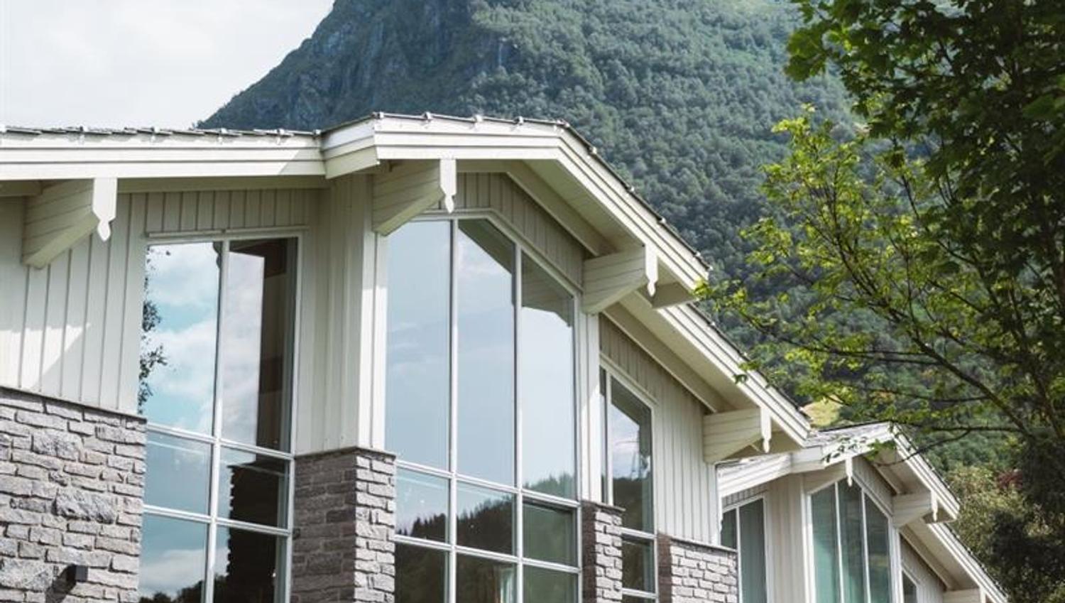 Fasaden til Rosendal Fjordhotel med fjellandskap i bakgrunnen