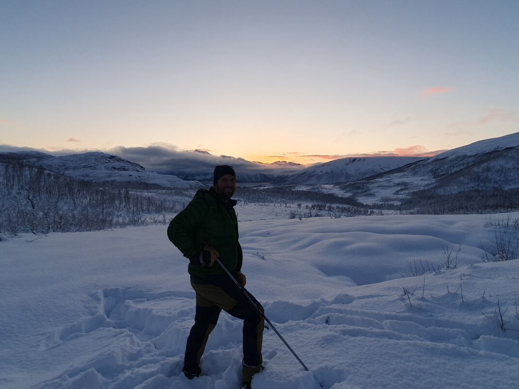 A guest looks out from the mountains as the sun goes down