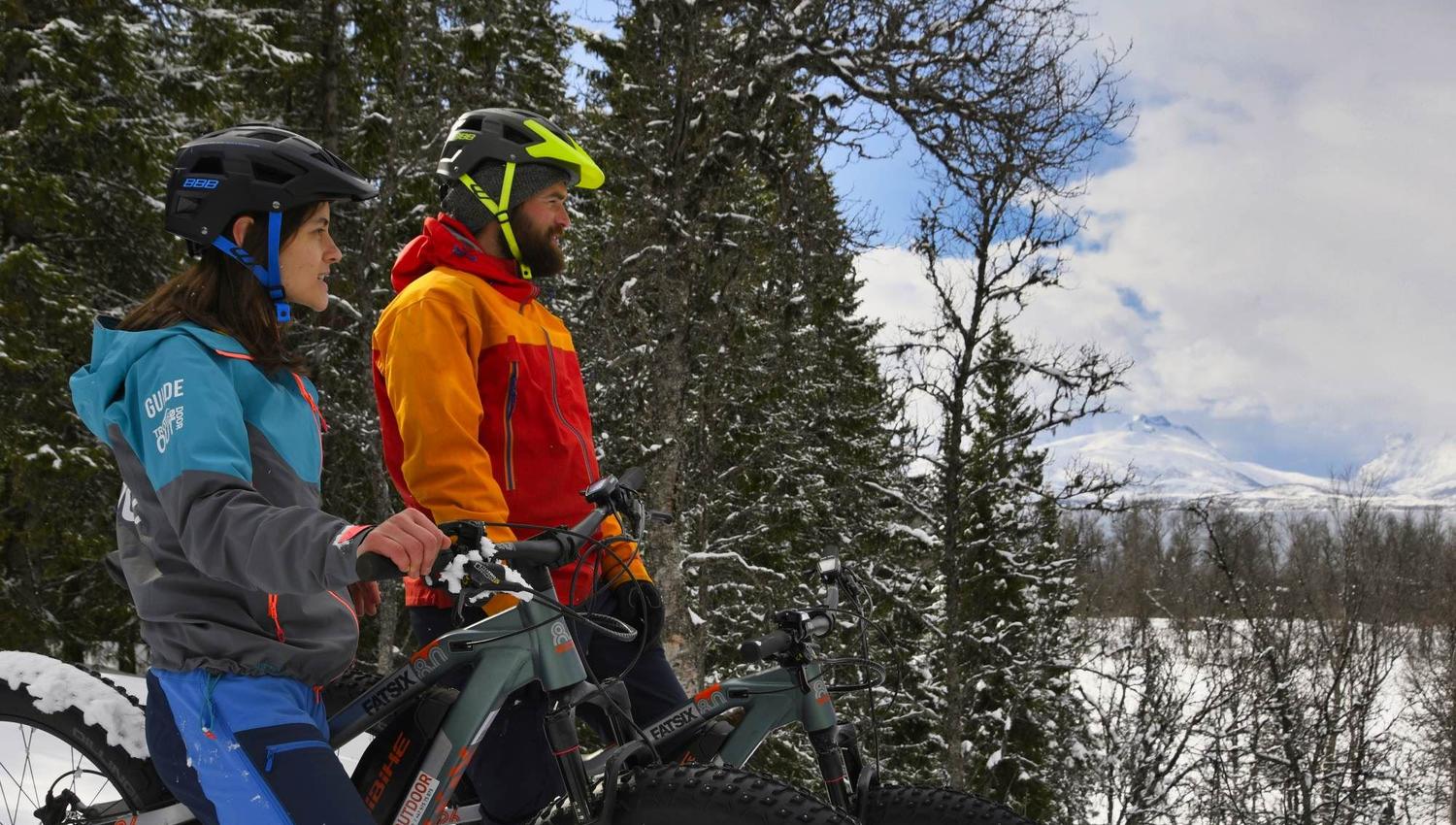 Two persons enjoying the view from their fatbikes