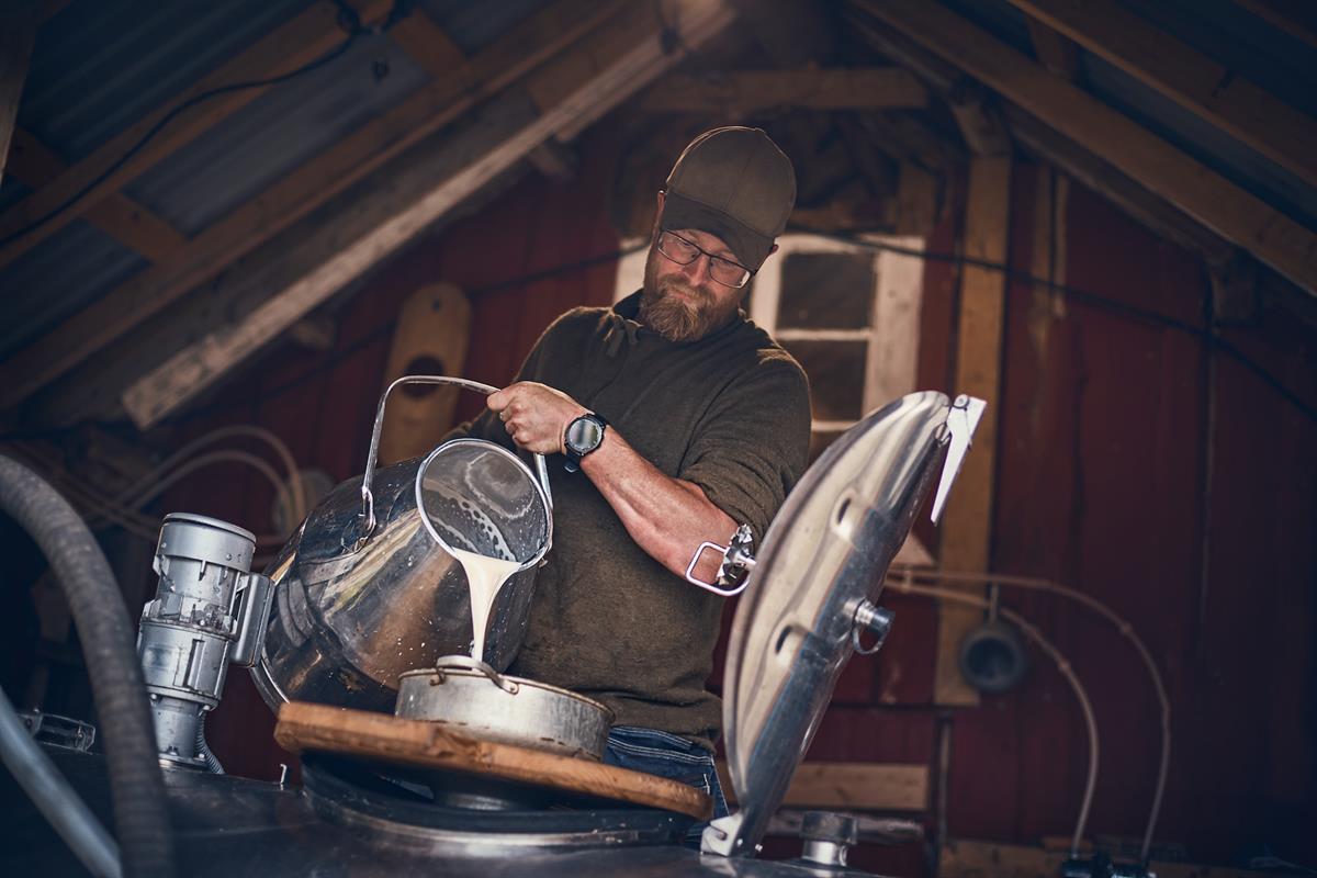 Man pouring milk.