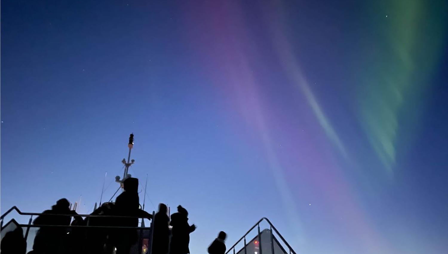 View of the Northern Lights from the top of the deck on the Brim catamaran