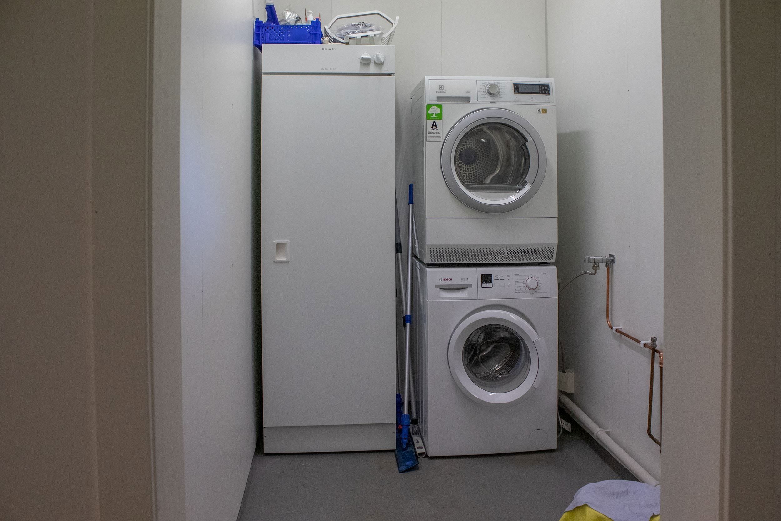 A washing machine and a dryer in a laundry room.