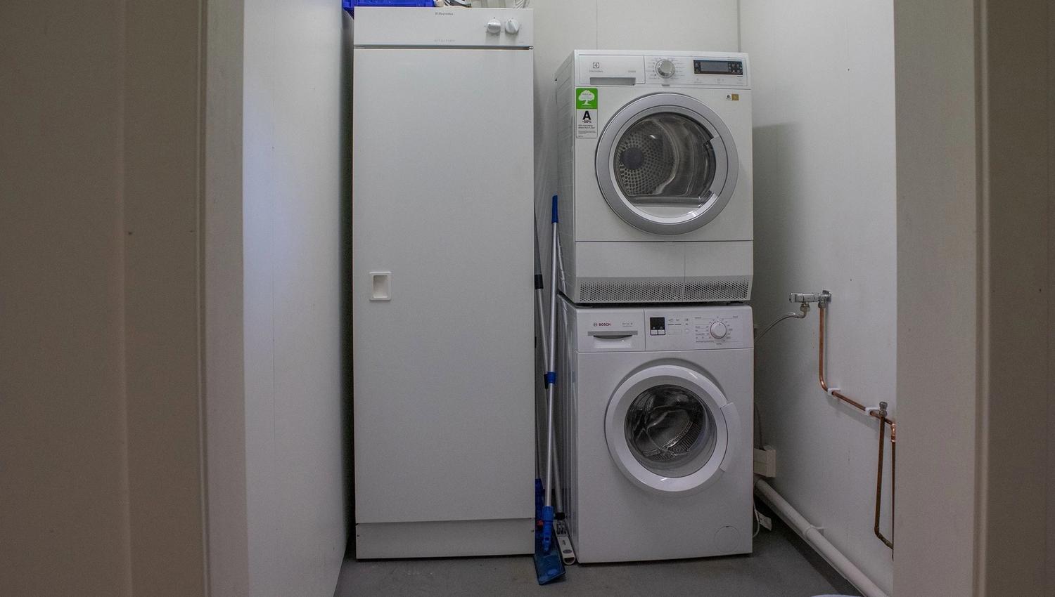 A washing machine and a dryer in a laundry room.