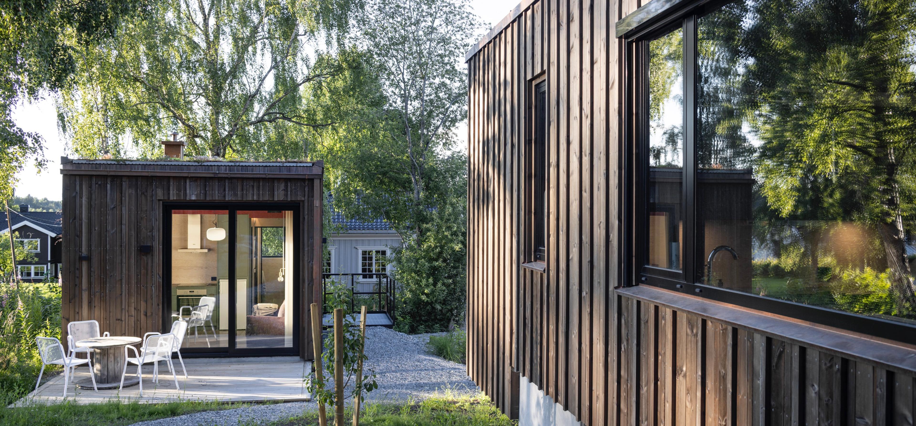 Small and tine micro house among green lush 