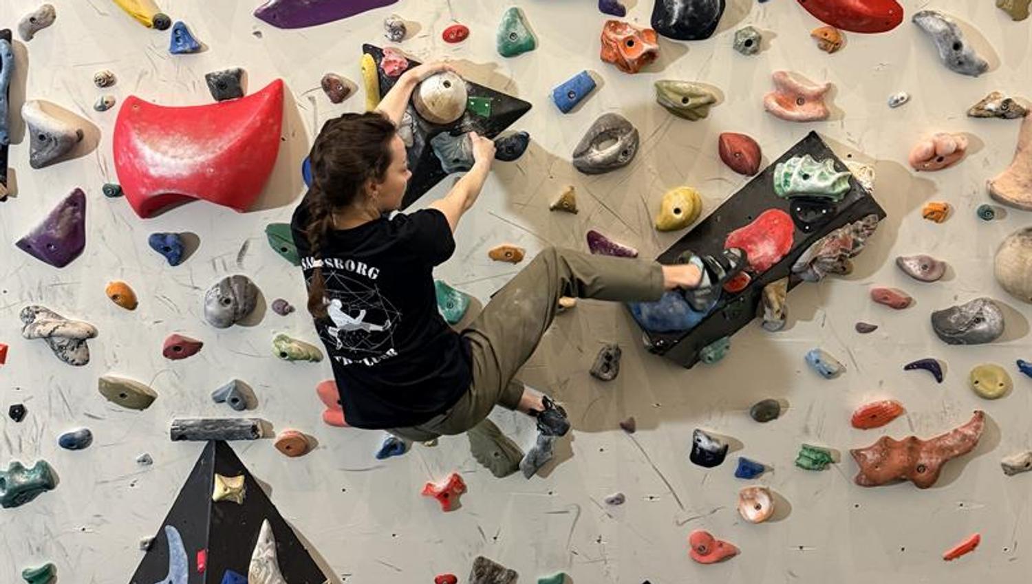 one person climbing at a boulder wall