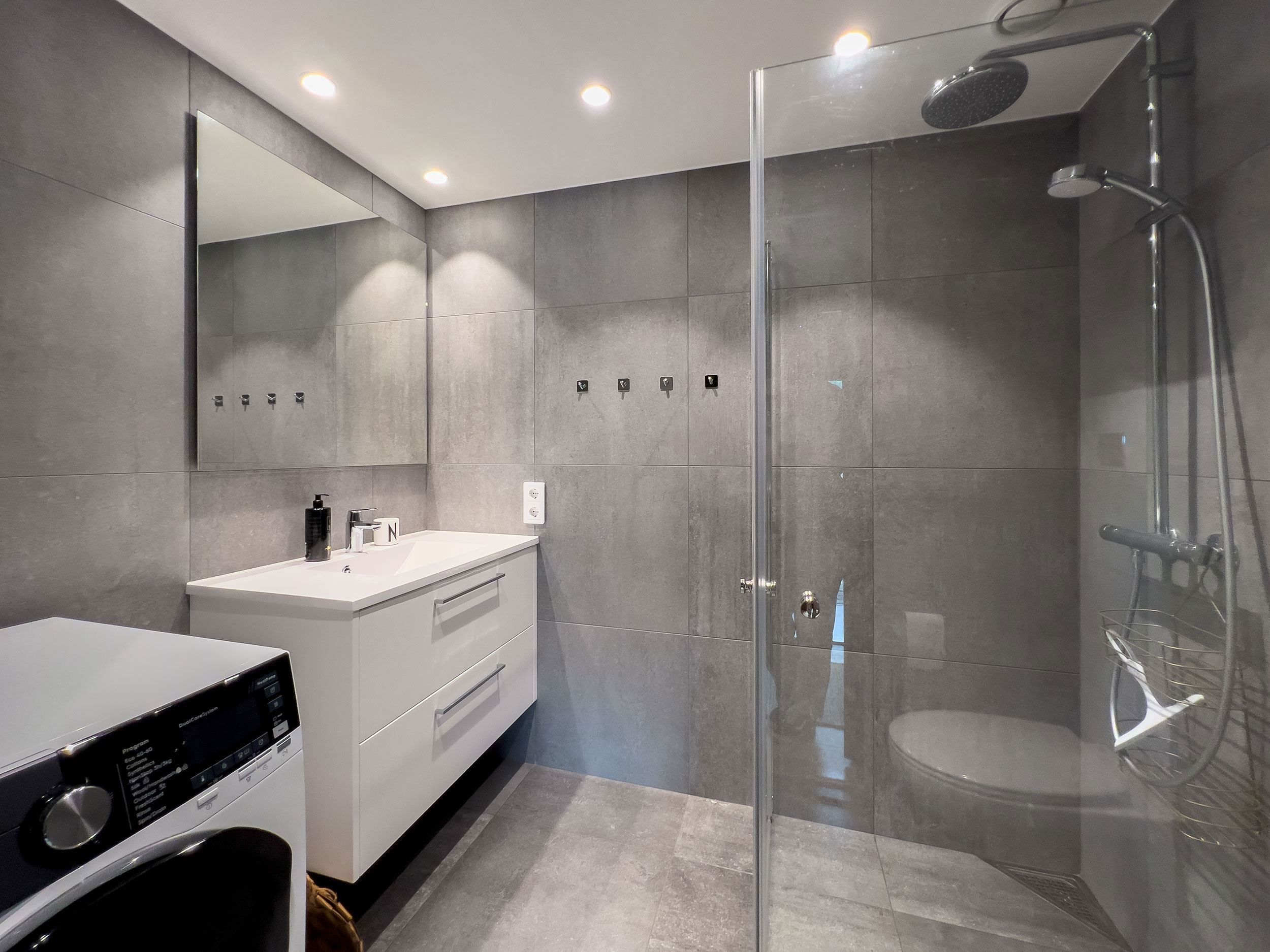 A bathroom with a glass shower door.