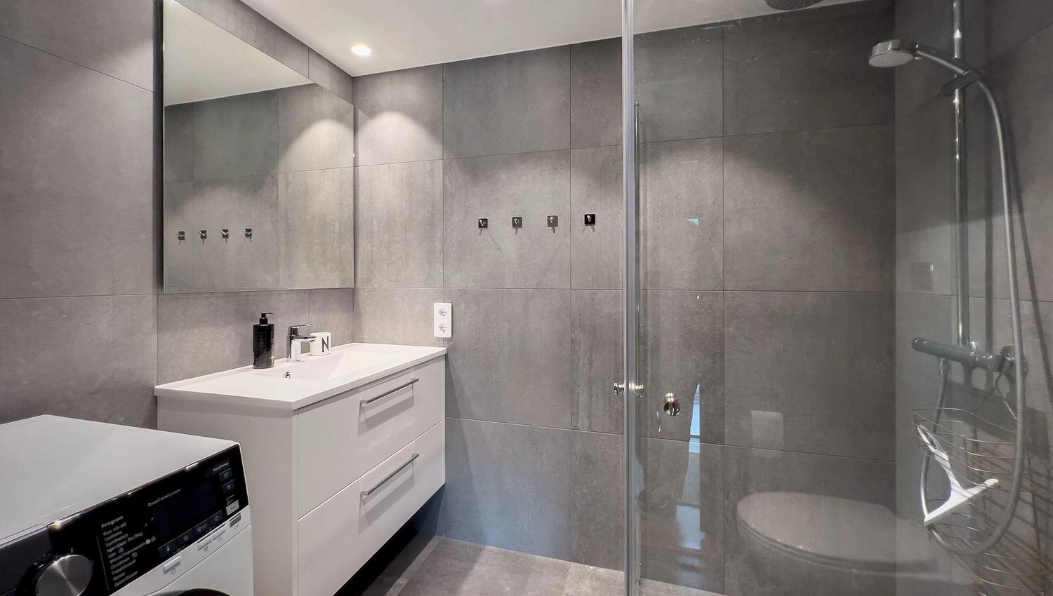 A bathroom with a glass shower door.