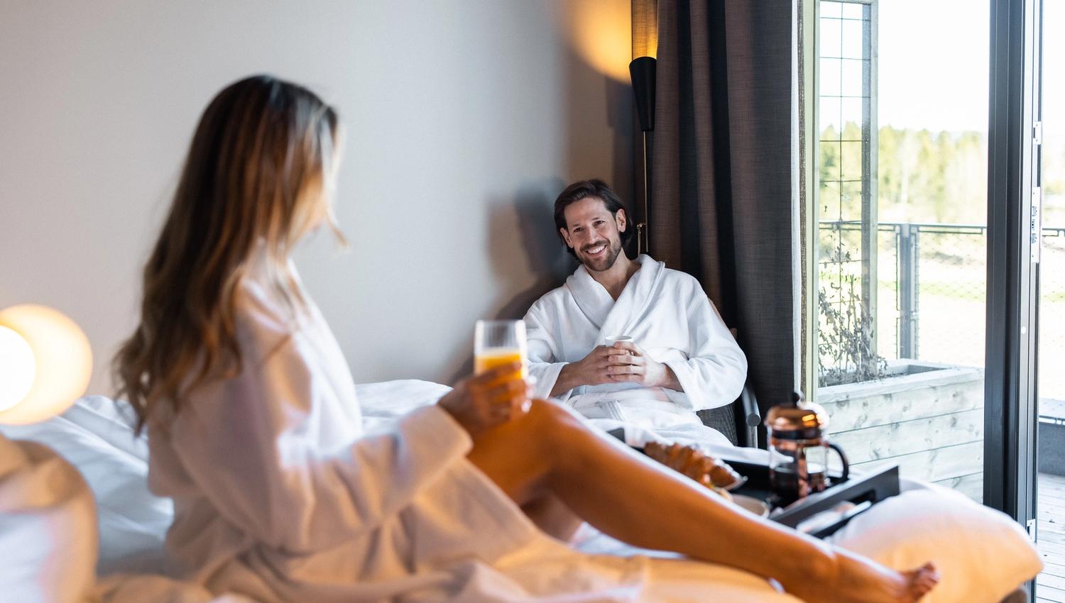 Couple eating breakfast in bed