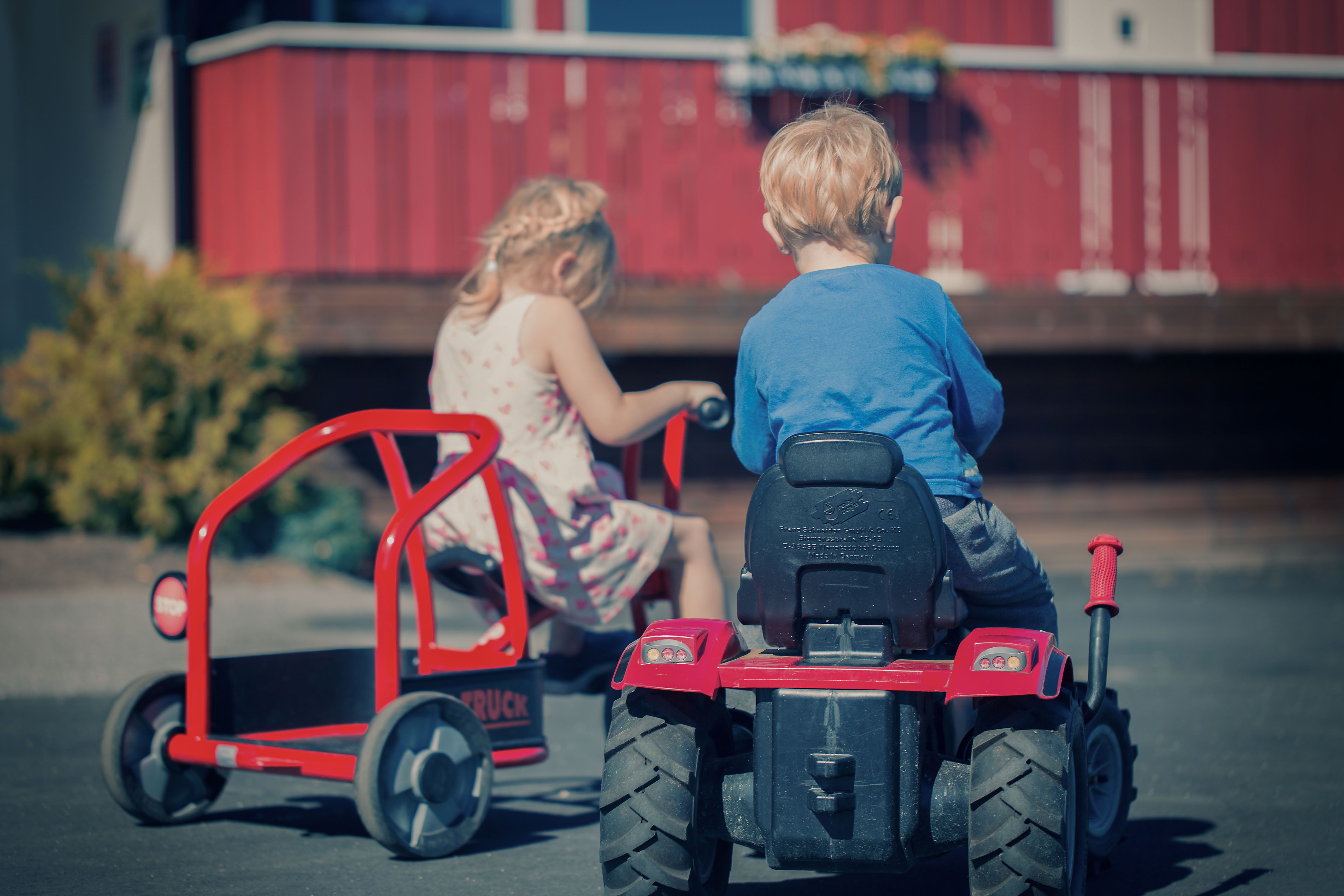Two children play with toy vehicles