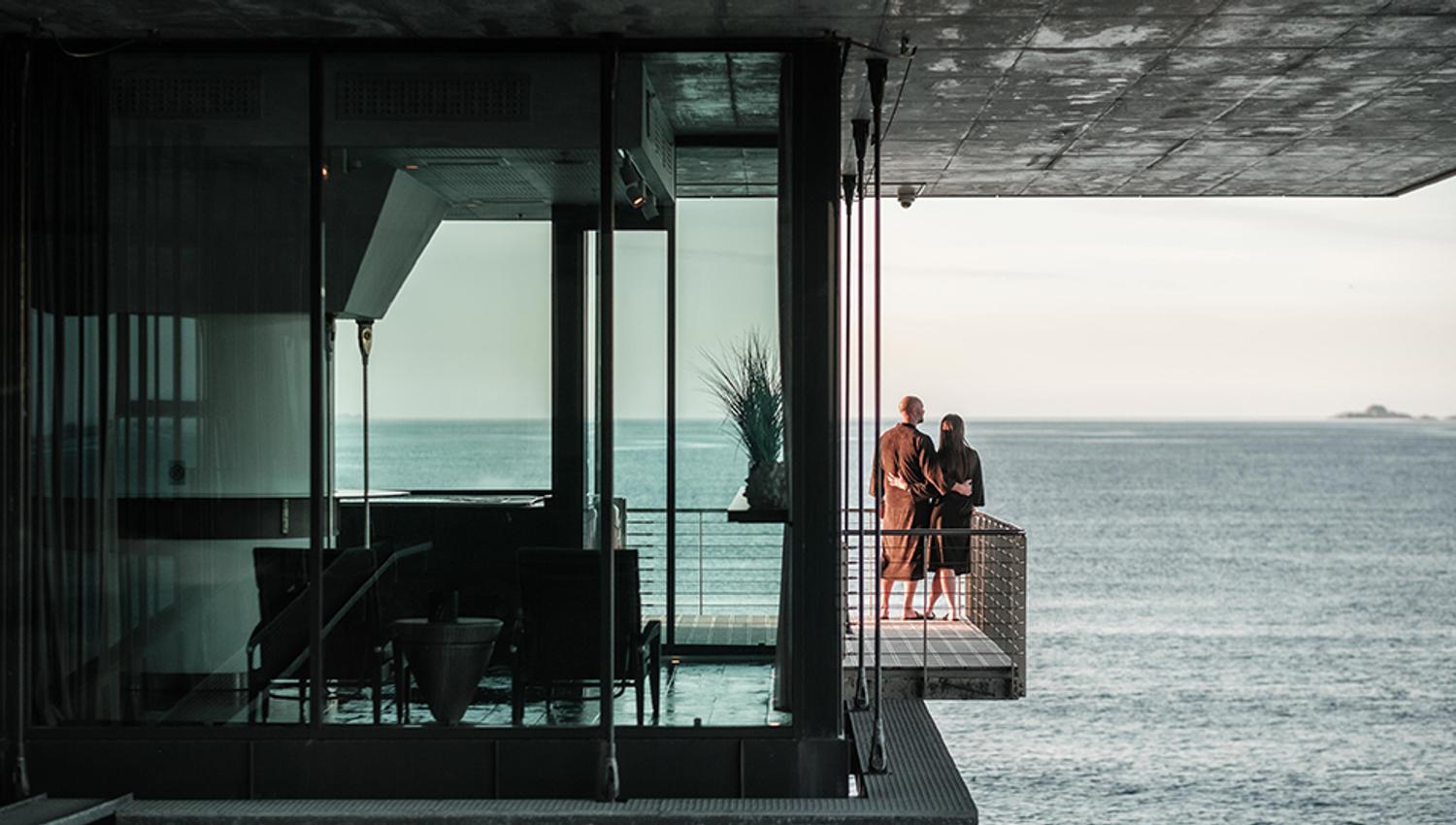 To personer ser utover havet fra hotellet