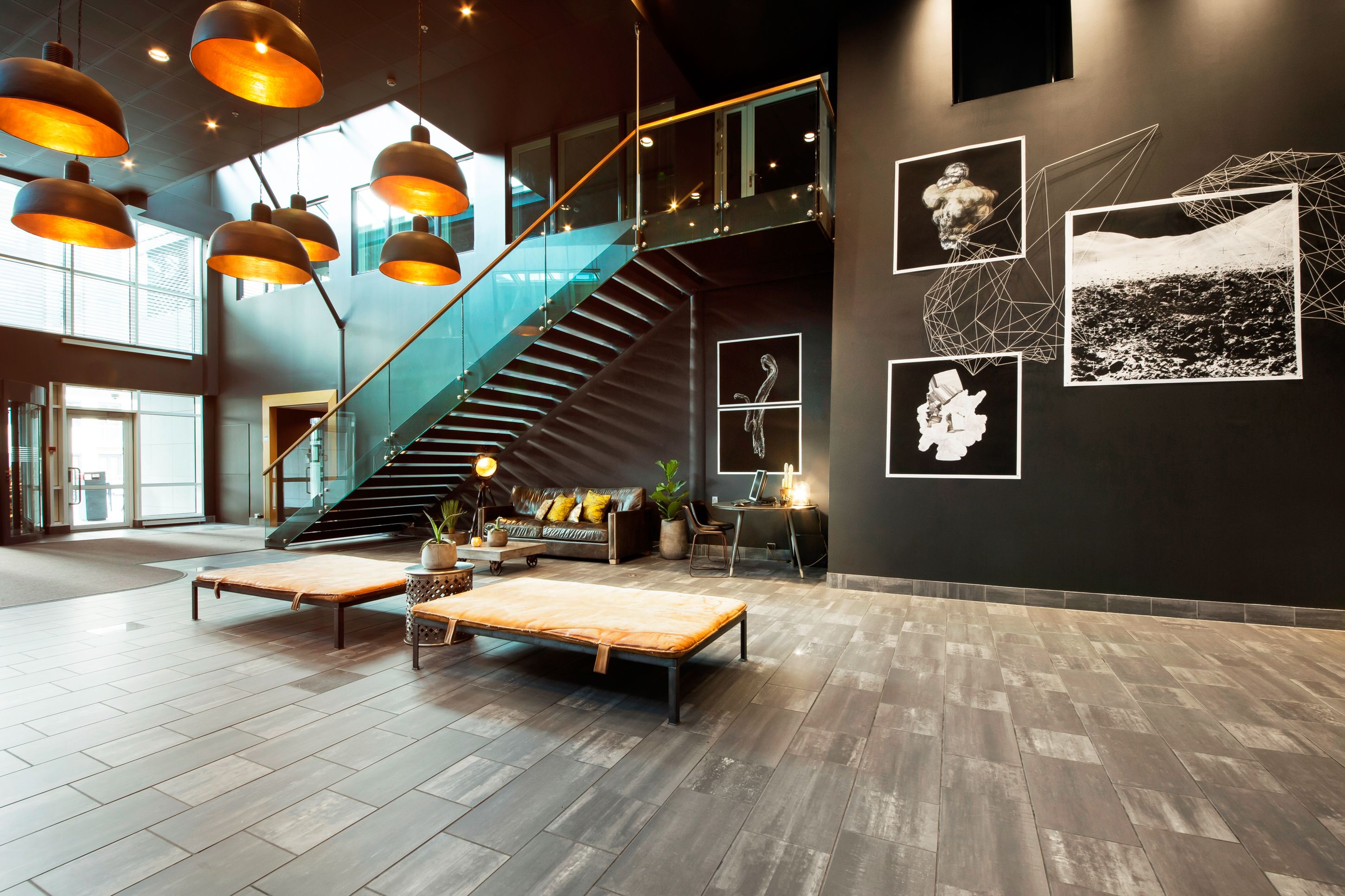 Lobby and entrance. Black-and-white art on the walls. Photo.