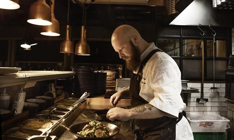 A cook preparing food