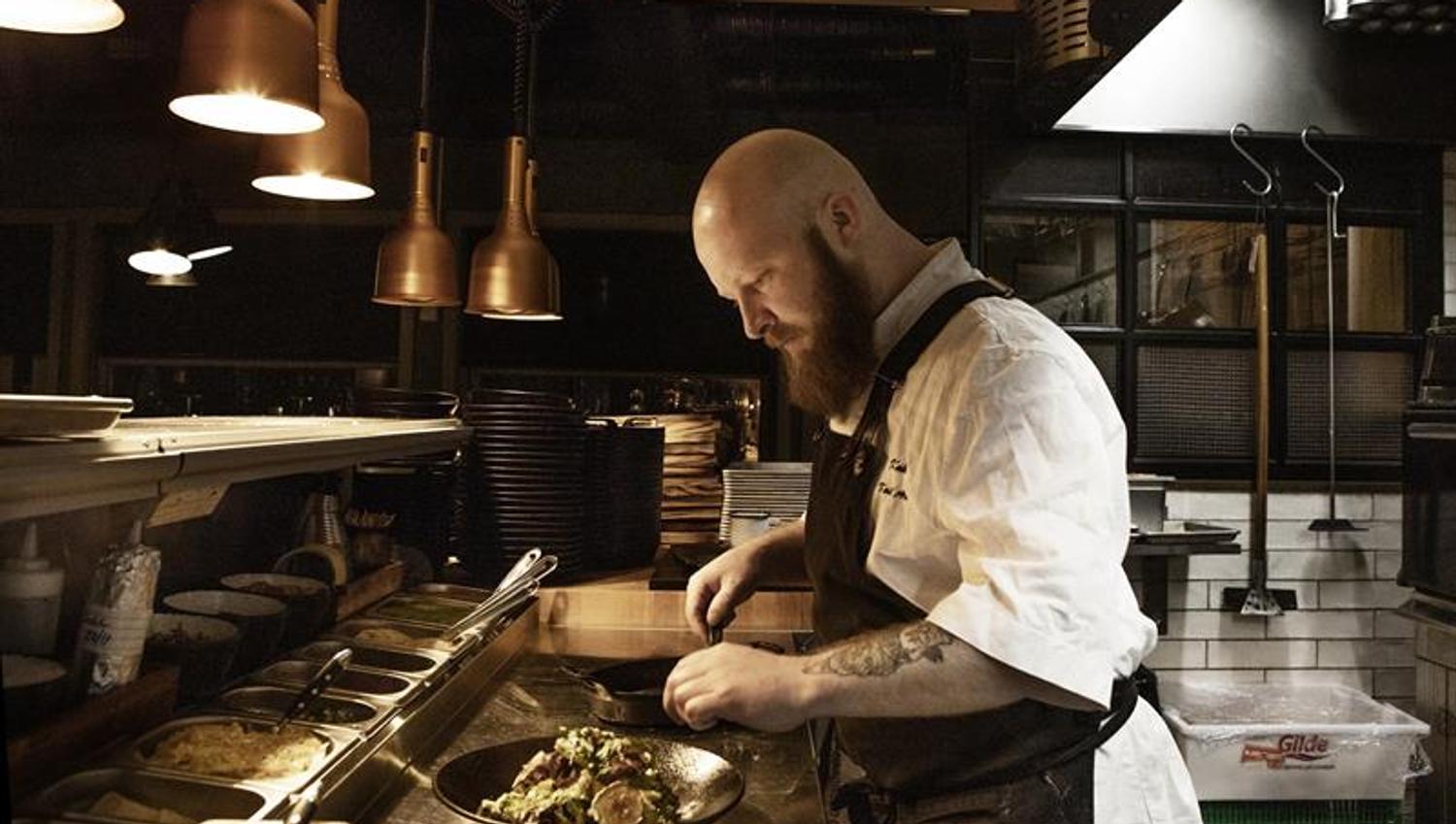 A cook preparing food
