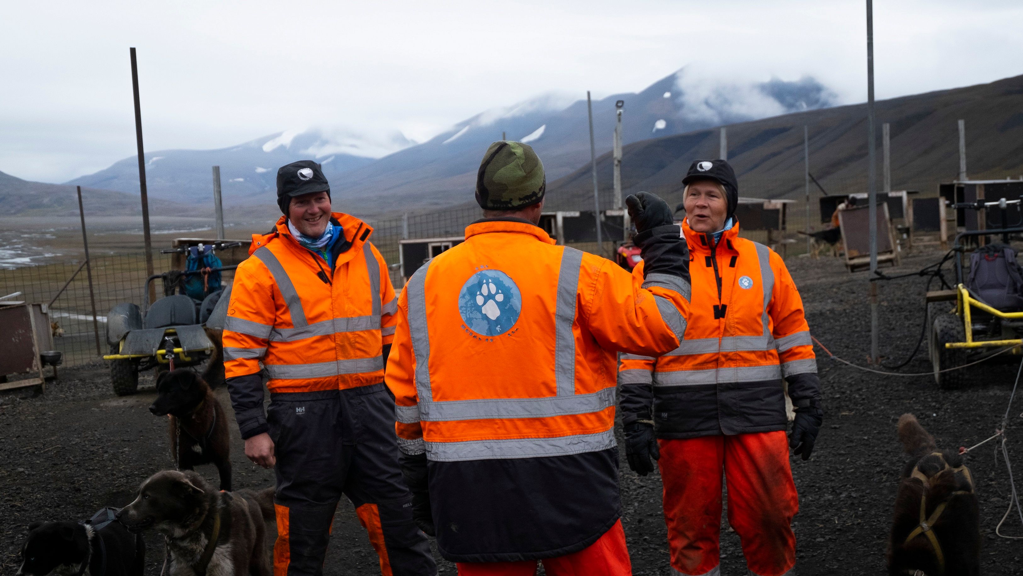 A guide giving instructions to guests inside the dog yard