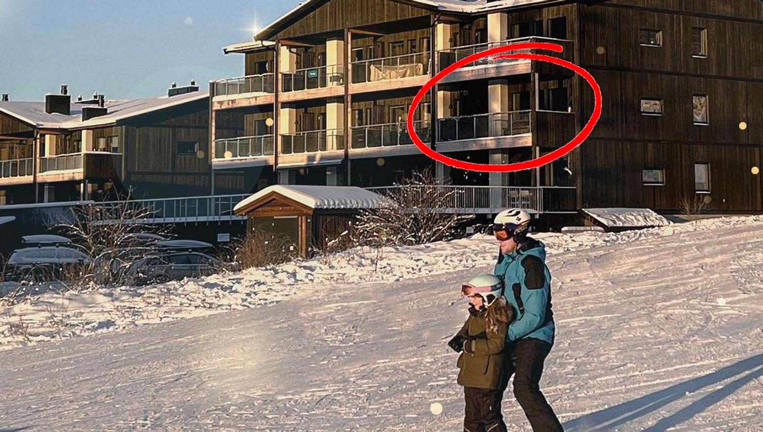 A person and a child skiing in the snow.