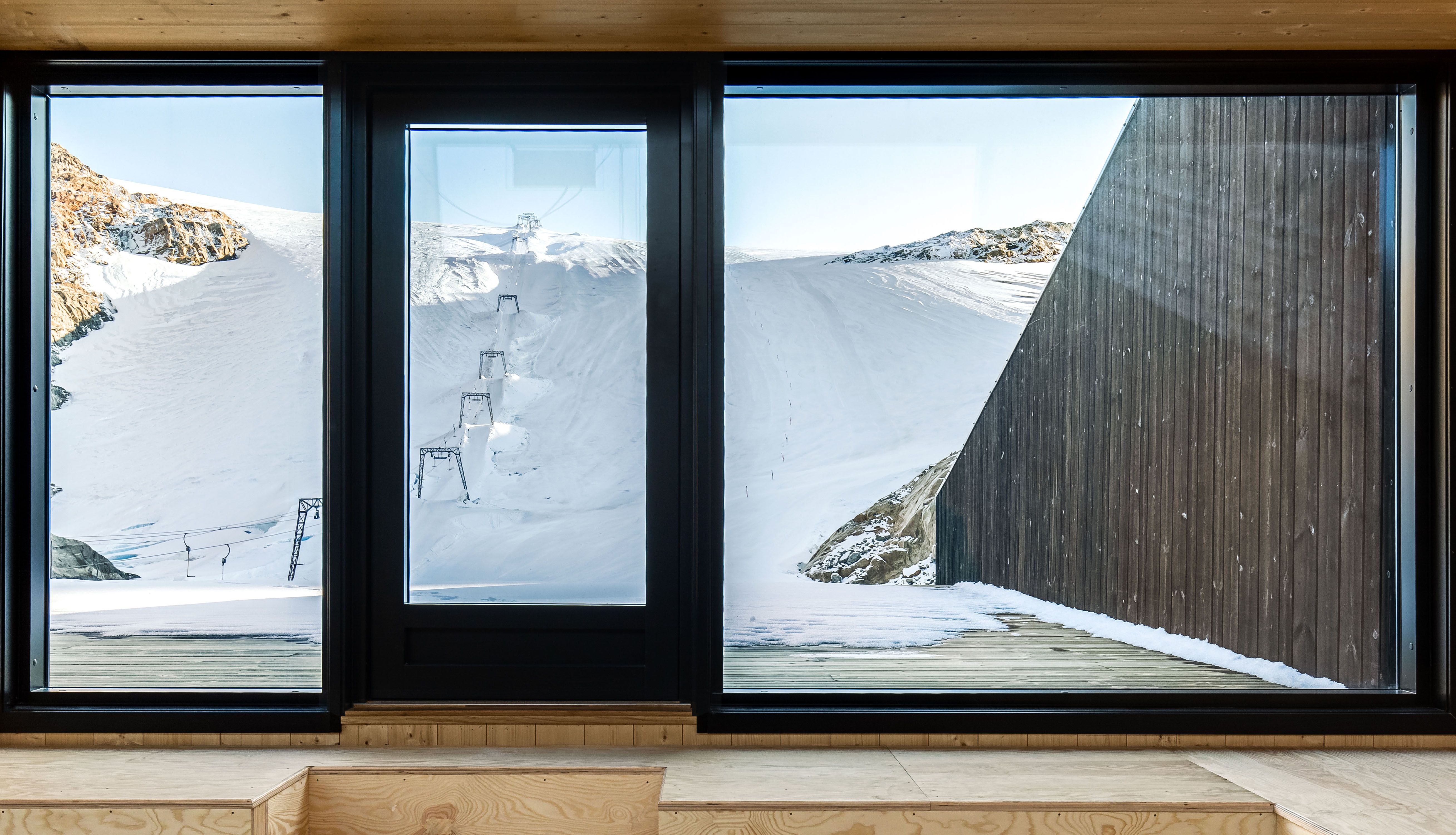 Large windows at Fonna1199 offering panoramic views of the glacier and surrounding mountains