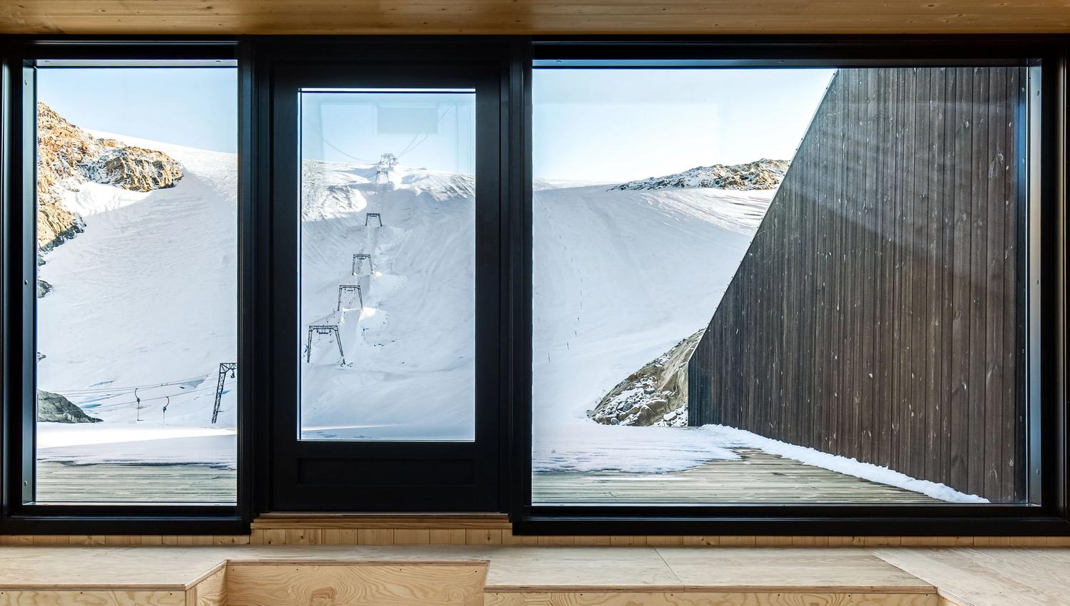 Large windows at Fonna1199 offering panoramic views of the glacier and surrounding mountains