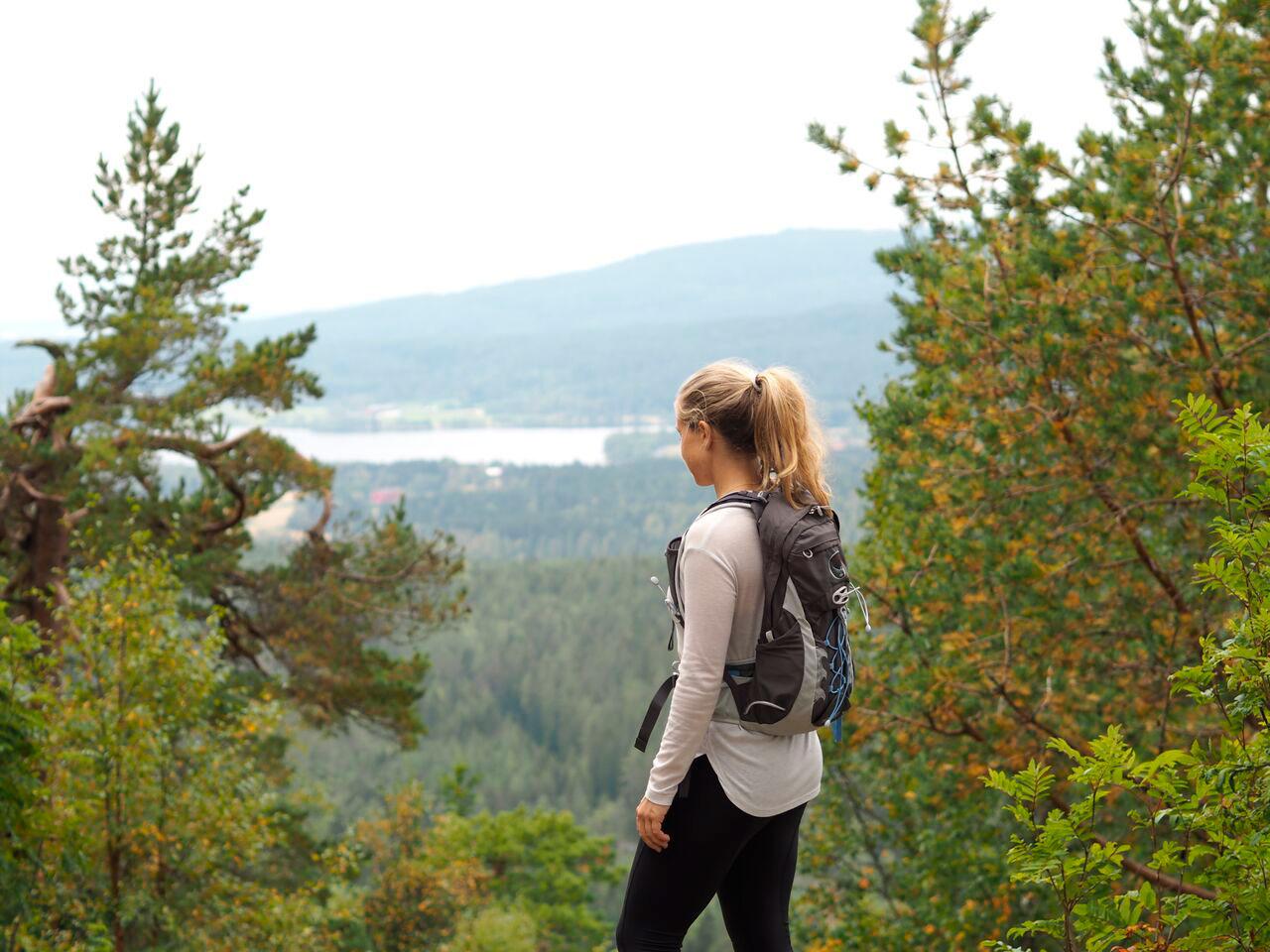 woman in the woods with a backpack on her back